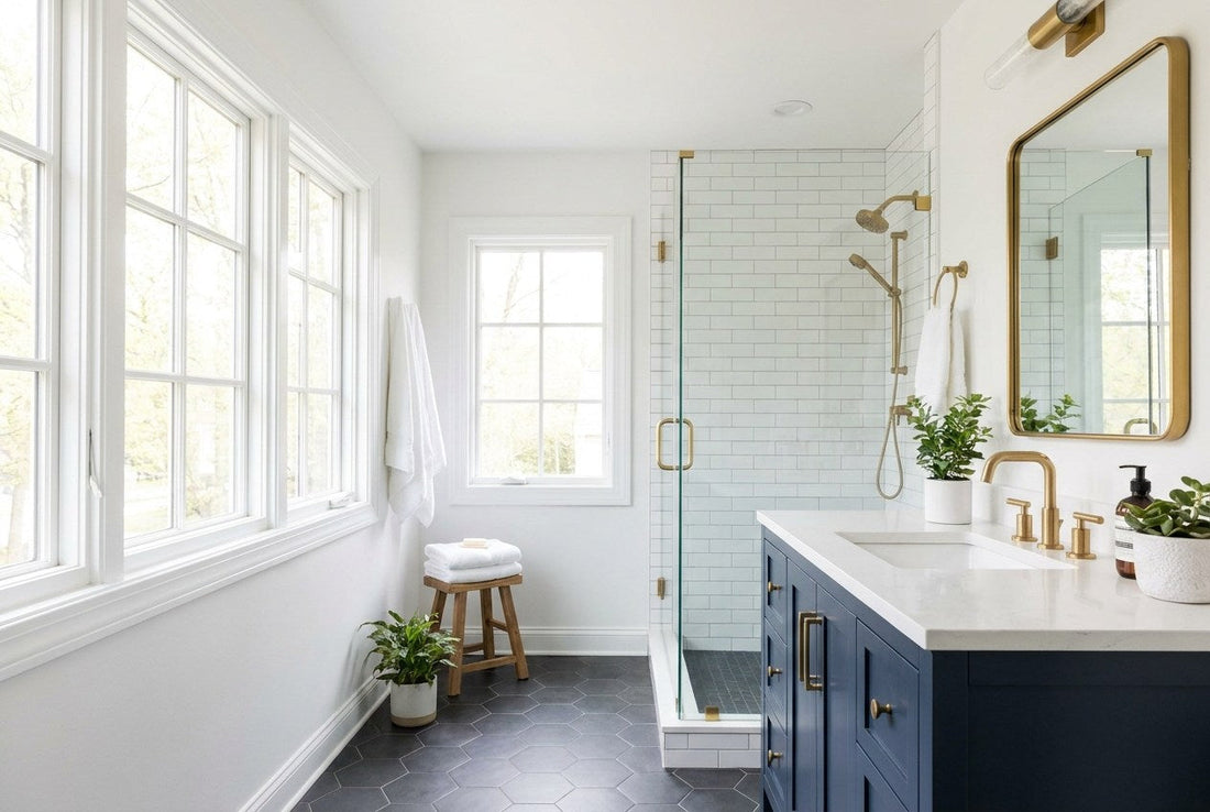 Remodeled American bathroom with a navy vanity, brass fixtures and a subway-tiled walk-in shower