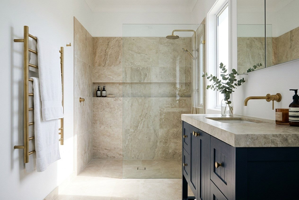 Renovated Australian bathroom with a navy timber vanity, brass tapware and a frameless walk-in shower