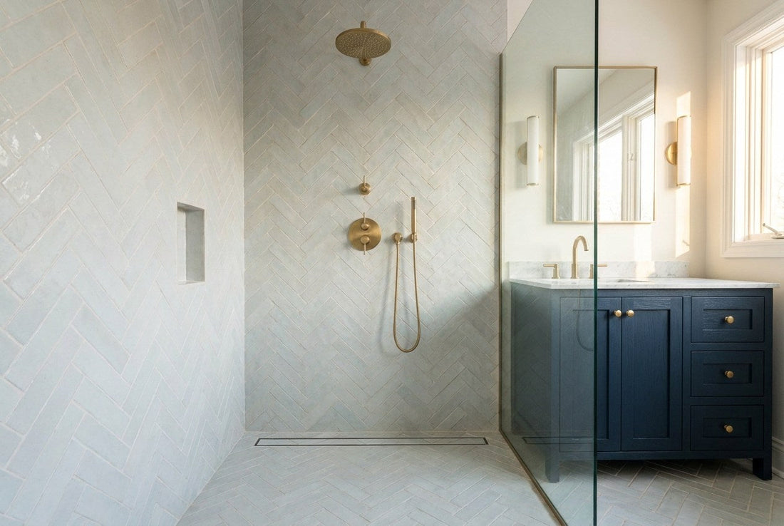 Renovated bathroom walk-in shower with fresh tiling and brass fittings