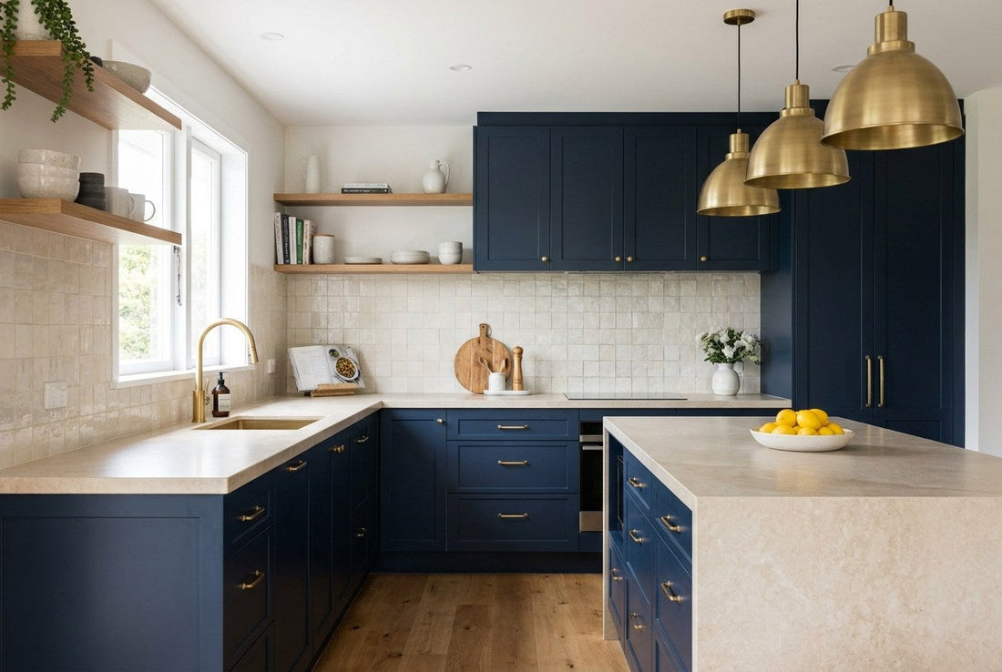 A finished New Zealand kitchen renovation with navy Shaker cabinetry, a pale stone benchtop, brushed brass fixtures and a tiled splashback