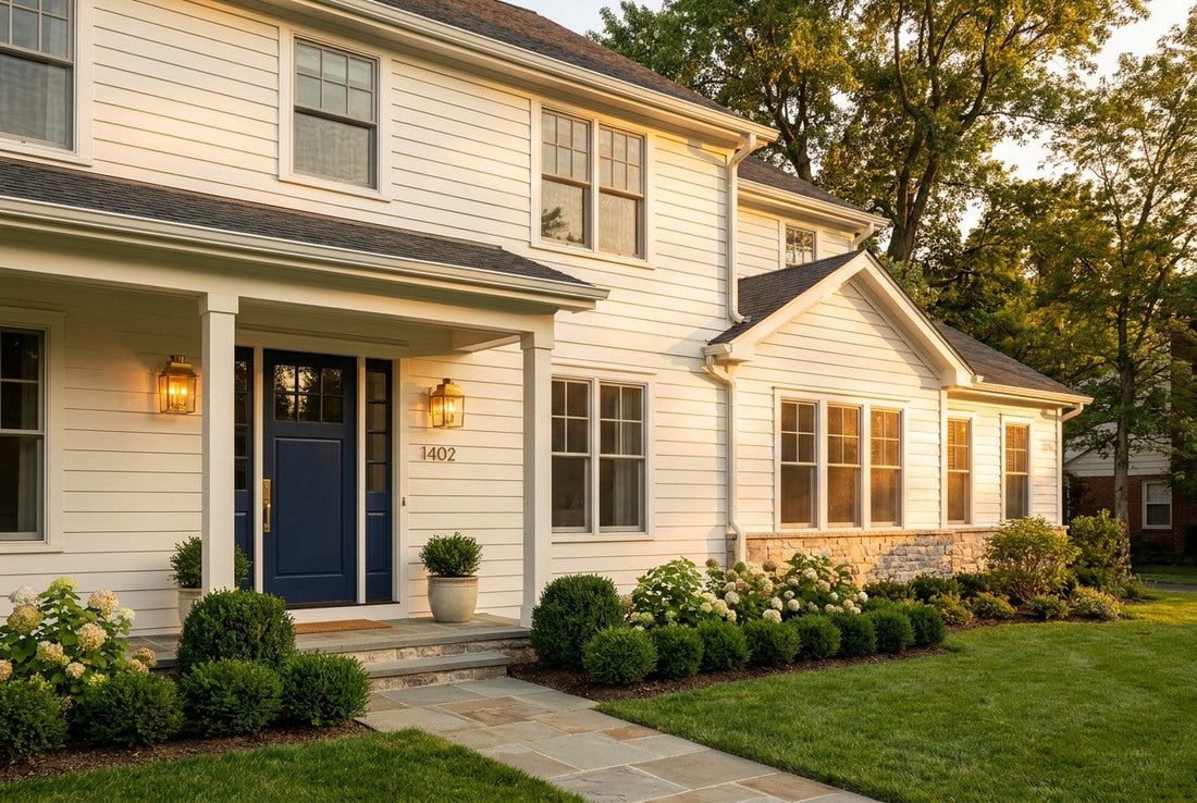 Fully renovated American suburban house exterior with navy front door, brass hardware and manicured landscaping