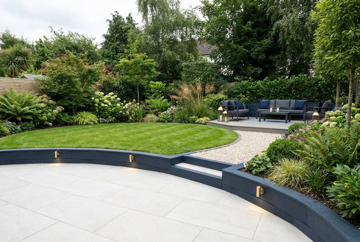 Fully renovated Irish back garden with porcelain patio, composite decking, navy and brass accents, showing the finished result of the correct garden renovation order of trades