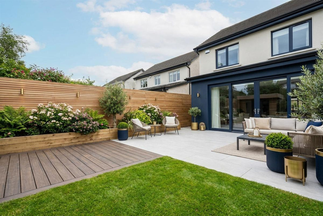 Finished landscaped Irish back garden with a porcelain patio, composite decking, lawn, planted borders and a modern timber fence