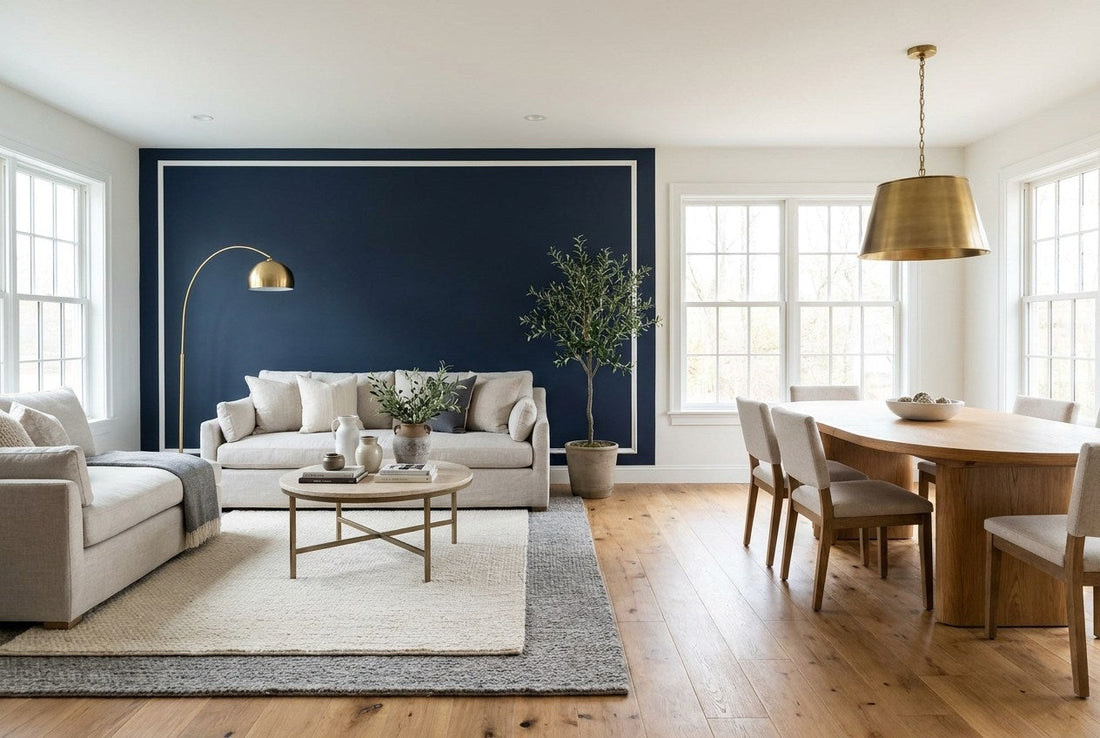 Fully remodeled US open-plan living and dining room with navy accent wall, brass lighting, and oak flooring
