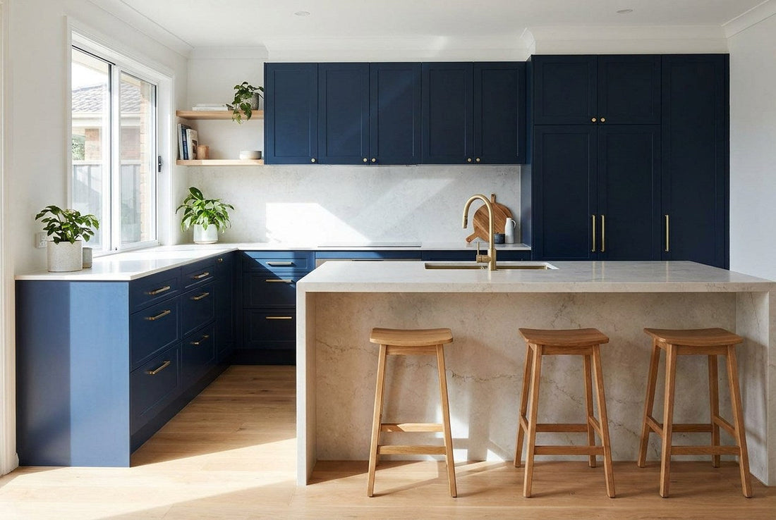 A finished Australian kitchen renovation in navy cabinetry with brass tapware and a stone island