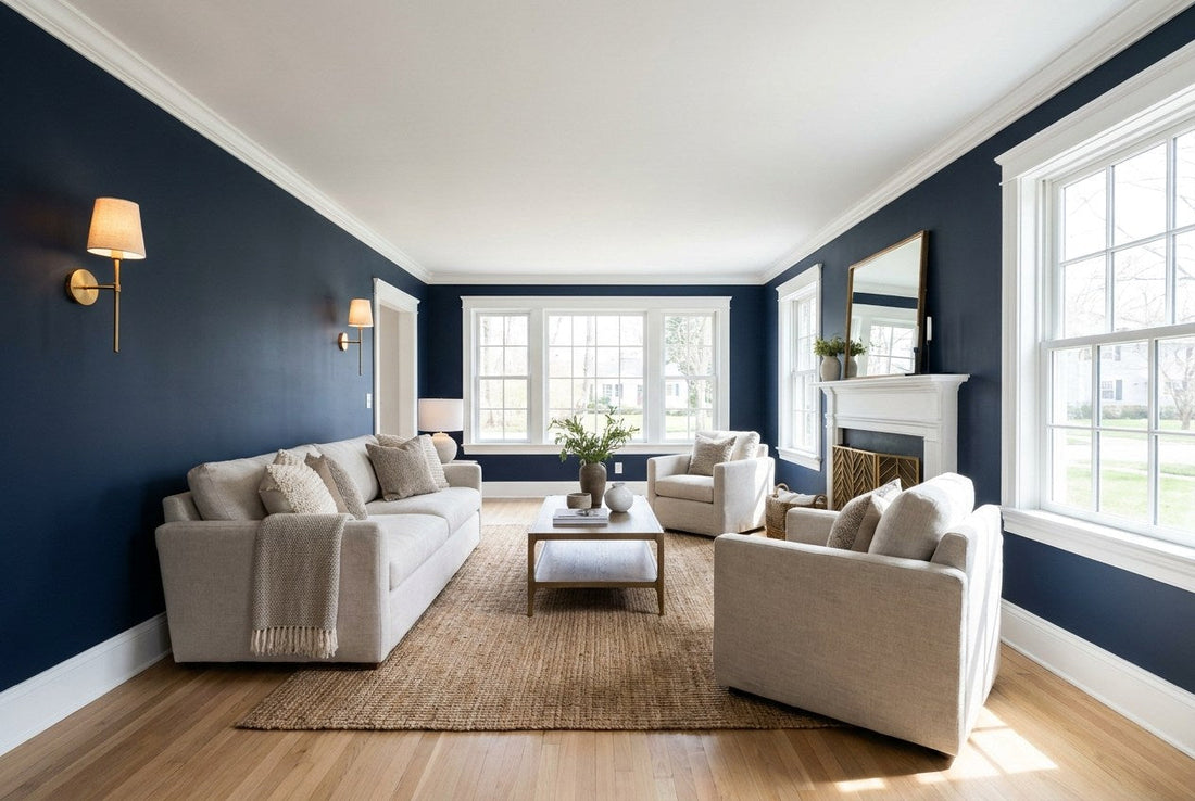 Finished American living room with a deep navy accent wall, white ceiling and trim, brass sconces, and a neutral sofa on an oak floor