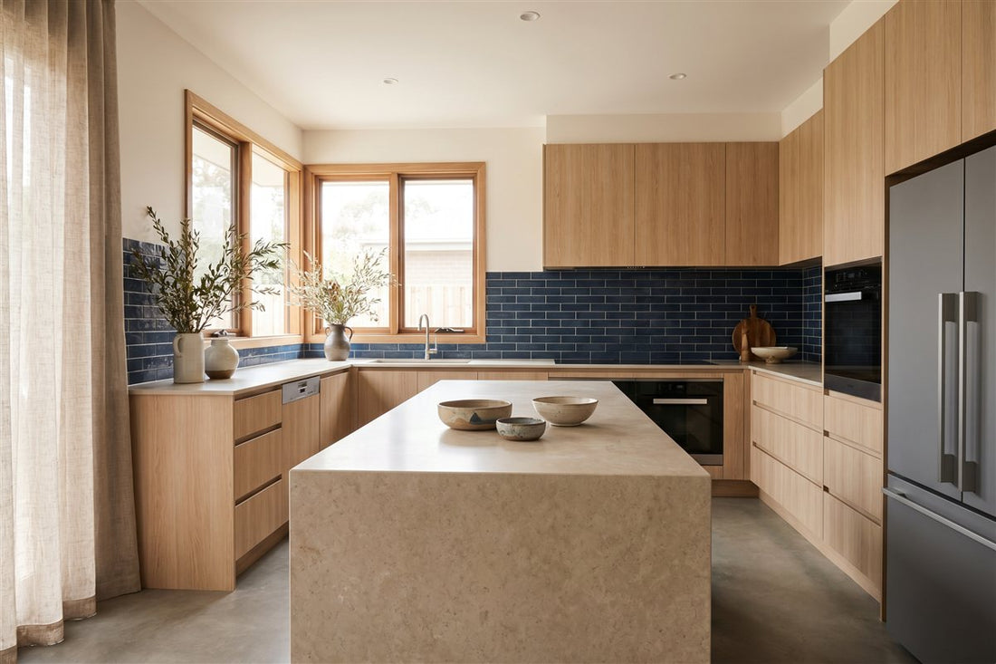 Renovated modern Australian kitchen with a stone island benchtop and handleless cabinetry