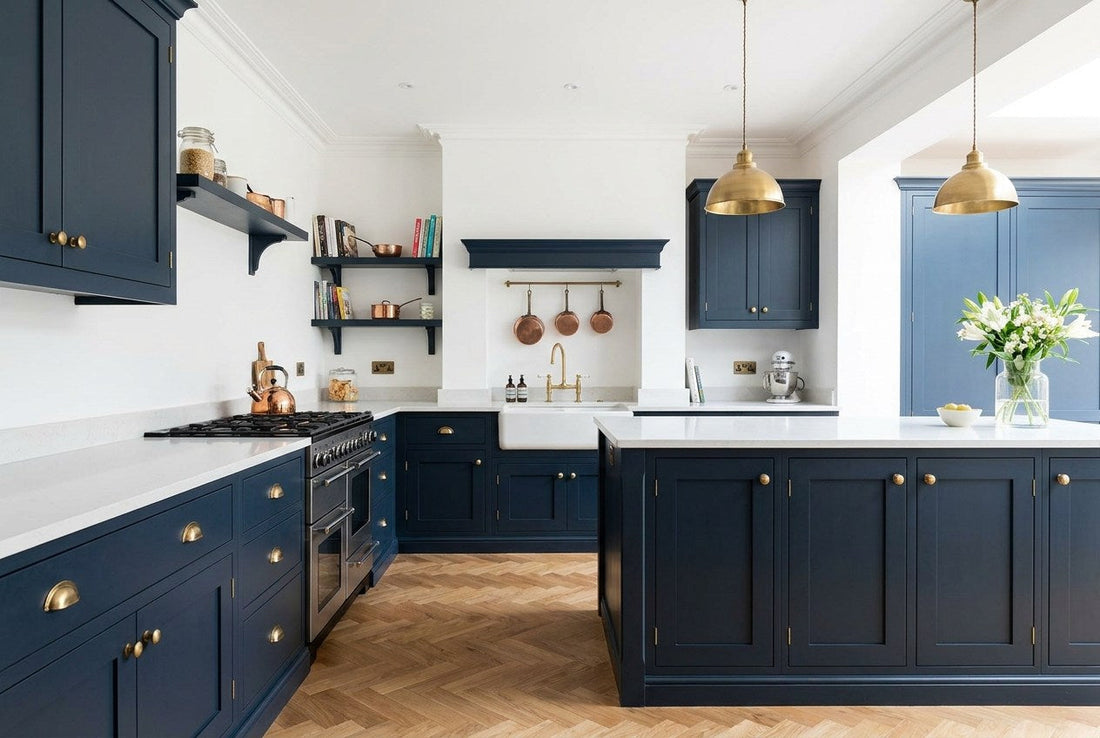 Renovated British kitchen with navy Shaker cabinetry, brass cup handles, a range cooker and a Belfast sink