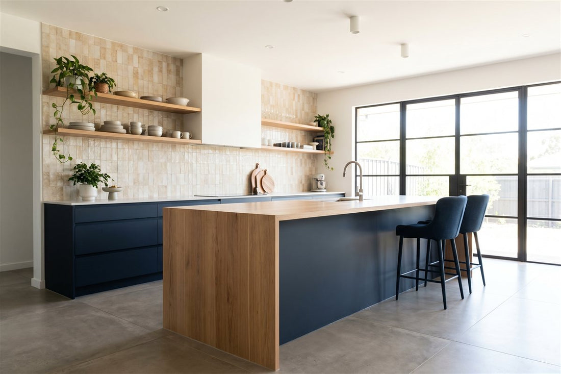 Renovated Australian kitchen with a central island, open timber shelving and a tiled splashback
