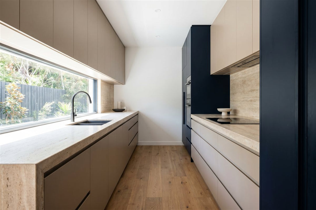 Renovated Australian galley kitchen with handleless cabinetry and a stone benchtop