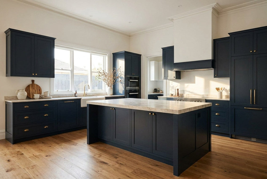 Renovated kitchen with navy shaker cabinetry, brass hardware and a marble island