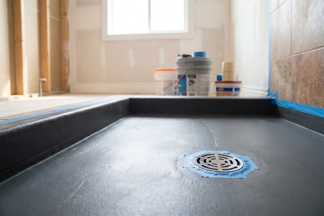 Bathroom shower base with freshly applied waterproofing membrane before tiling at an inspection hold point