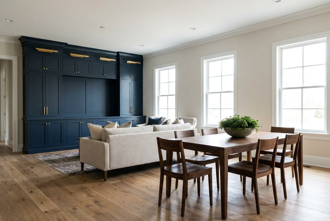 Completed open-plan living and dining area in an American home with navy built-in cabinetry, brass lighting and oak flooring