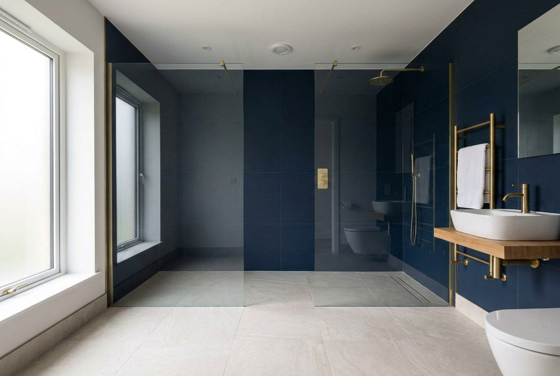 A finished level-access wet room in an Irish home with a continuous tiled floor, linear drain and frameless glass screen