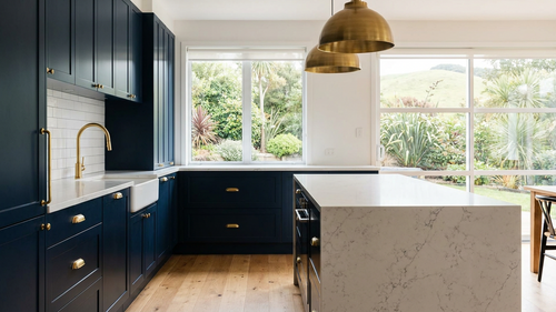 Beautifully renovated Australian kitchen with navy cabinetry and brass finishes — the result the Kitchen Renovation Blueprint helps you plan